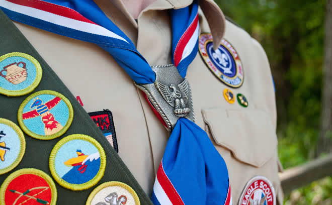 Scouting uniform, neckerchief, and merit badge sash